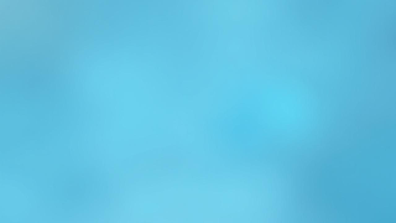 Close-up of a gloved hand meticulously wiping down a medical examination table with disinfectant